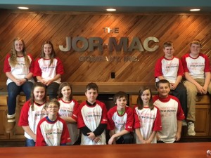 Students in front of Jor-Mac Logo