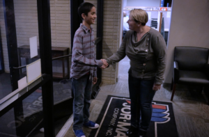 Fond du Lac Works screen shot Kelly shaking hands with young boy